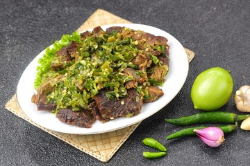 Dendeng Batokok Cabe Ijo is a dish rich in flavor and texture, combining tender beef jerky with fresh and spicy green chili sauce.