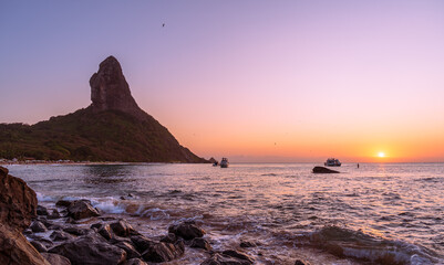 Fernando de Noronha&acute;s most famous peak viewed during a sunset over the sea