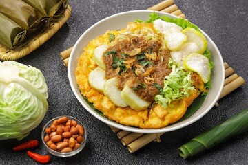 Tahu tek, tahu gunting, tahu telur is a typical Surabaya food consisting of fried tofu, rice cake, fried potatoes, bean sprouts and cucumber, which are drizzled with peanut sauce.