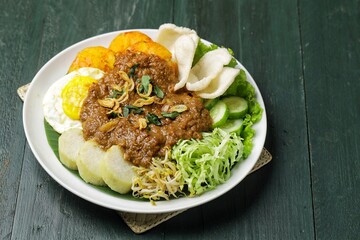 Tahu gimbal is a dish consisting of fried tofu, shredded raw cabbage, rice cake, bean sprouts, eggs, and gimbal mixed with a distinctive peanut sauce because it uses shrimp paste.