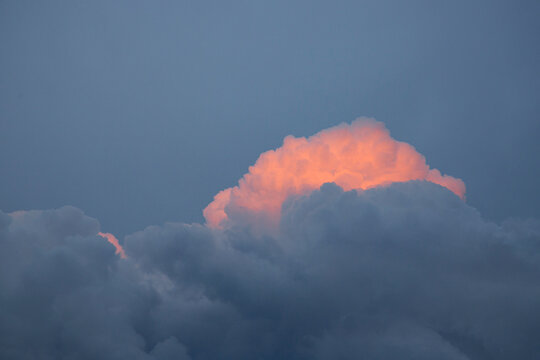 close up Reflection of sunlight in sunset clouds. A beautiful pink cloud against a background of blue clouds