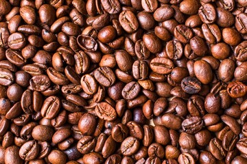 Close up macro view of roasted coffee beans texture background
