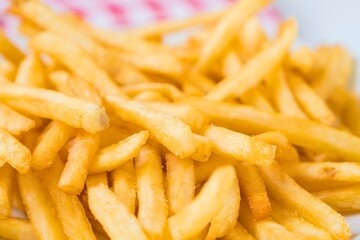 Golden brown french fries pile close up