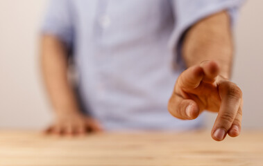Close-up shot of a hand pointing forward, representing choice, direction, or a call to action. Symbolizes decision-making, future, and focus.