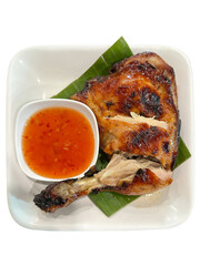 Grilled chicken with chili sauce on a white plate, isolated on transparent background.