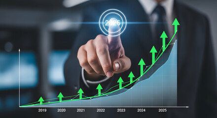 Businessman pointing at a glowing digital graph showing upward financial growth and success