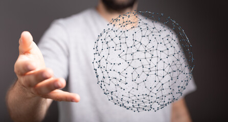 Close up of a hand holding a glowing digital sphere, representing technology, connection, and data...