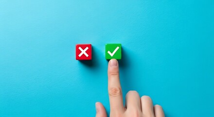 Finger pointing to a green checkmark cube on blue background correct right
