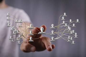 Hand touching network of connections, representing communication, teamwork, and business strategy. Visual metaphor for business, cooperation, an