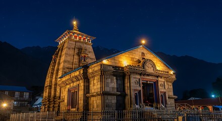 Kedarnath Temple illuminated at night under starry sky