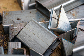 Metal scrap after cutting process, industrial waste, close-up of sharp metal scraps.