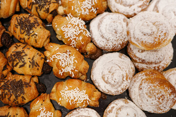 Assortment of ensaimadas and mini croissants on a tray