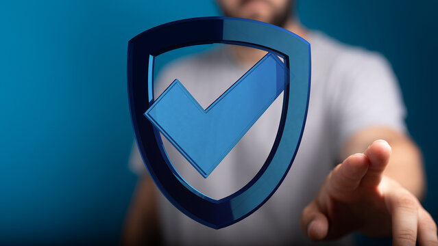 A person interacts with a digital shield icon with a checkmark, representing data protection, cyber security, and successful validati
