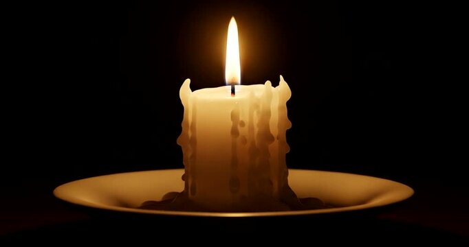Burning candle on a plate with wax dripping down isolated on black background