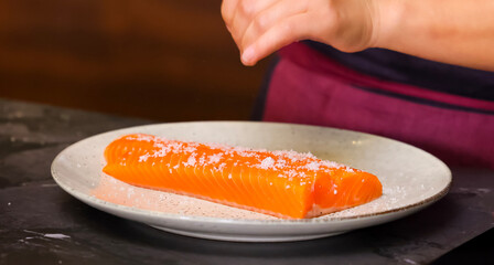 Sprinkle salt on salmon