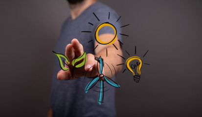 Concept of human hand interacting with a digital interface showing renewable energy sources like solar, wind, and plant life, symbolizing sustai