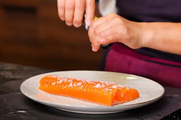 Sprinkle salt on salmon