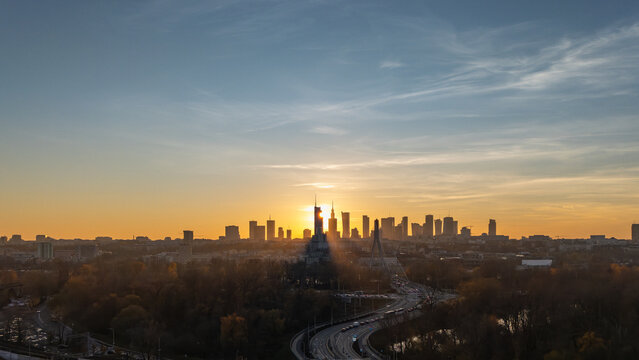Aerial view of Warsaw skyline at sunset – city panorama with Palace of Culture and Science, skyscrapers and Świętokrzyski Bridge, golden hour, Poland - Powered by Adobe