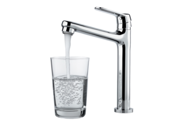 Chrome faucet filling a glass with water isolated on transparent background. Clear glass fills with fresh water from a stylish faucet isolated on white background.