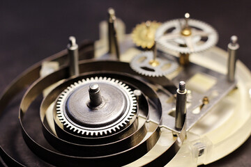 Retro mechanical watch mechanism, gears and metal parts.