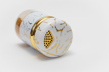 Luxury white spice jar with gold accents on white background