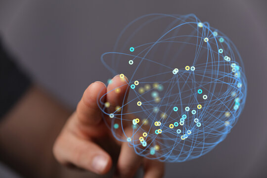 Close-up of a hand touching a digital globe, symbolizing global connection, data networks, and technological advancement. A futuristic and moder
