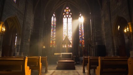 Sunlight beams through stained glass window in dark gothic church interior, illuminating wooden pews and stone wall, creating peaceful and spiritual atmosphere with warm beam light - Powered by Adobe