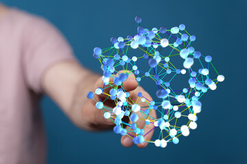 Person's hand interacts with a digital 3D network, signifying data connectivity, artificial intelligence, and technological advancement. Perfect