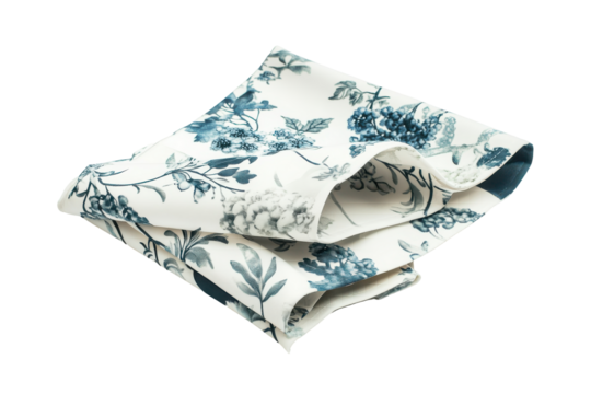 Folded white fabric with blue green leaf pattern isolated on transparent background.