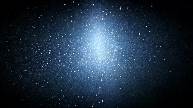 A dark blue image with bright, numerous dots fading away from a central glow