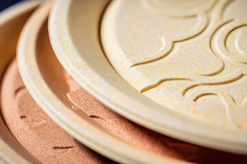  Close-up macro shot of biodegradable plate stack showing natural texture and detail. Eco-friendly product concept with neutral background and generous space for copy
