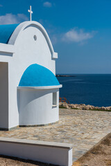 Traditional white chapel with a blue roof on the seaside. Agioi Anargyroi, Cyprus