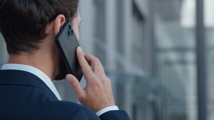 Back view unrecognizable Caucasian businessman talking phone business call man speaking discussion...