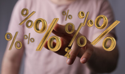 Hand reaching towards floating golden percent signs, representing discounts, finance, and investment opportunities. A visual of economic concept