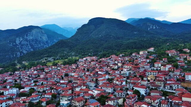 Greek town of Litochoro with small houses against the backdrop of the Mount Olympus and a cloudy sky