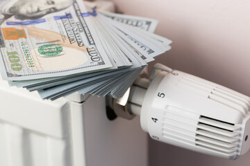 Money Stack on Heating Radiator Thermostat Symbolizing Cost
