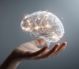 Hand holding glowing digital brain network against gray background