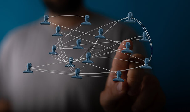 Hand interacting with digital network of people icons, symbolizing teamwork, collaboration, global business, communication and digital connectio - Powered by Adobe