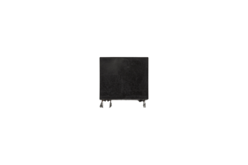 Old black rectangular electronic relay component with metal pins is isolated.