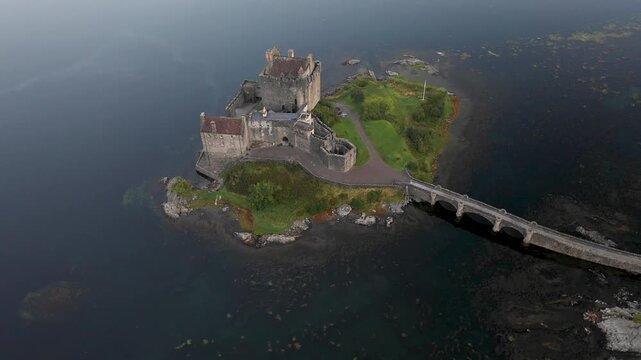 Aerial view of Eilean Donan Castle and lake Loch Duich in Scotland at sunrise