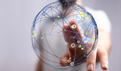 Concept of global connection and networking. A hand touching a globe representing the digital world. Shows network, technology, and c