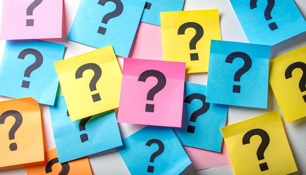Colorful sticky notes with black question marks scattered on white surface.