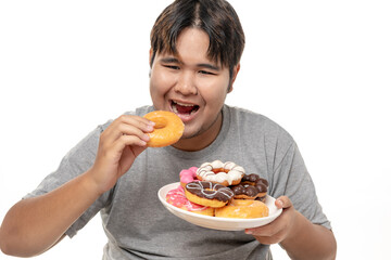 Young Asian fat man is enjoying eating delicious donuts on white background, tudio shot.