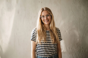 Smiling woman with blonde hair wearing glasses and a striped shirt