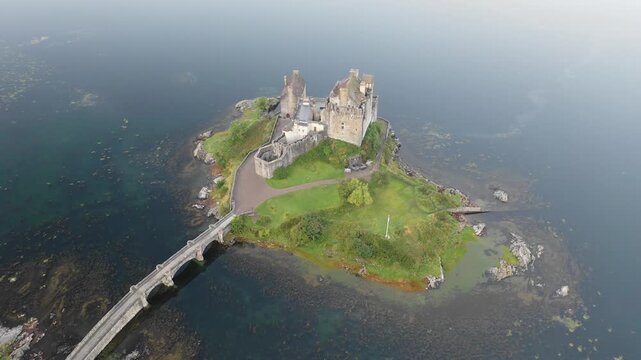 Aerial view of Eilean Donan Castle and lake Loch Duich in Scotland at sunrise