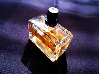 a bottle of parfume on dark background