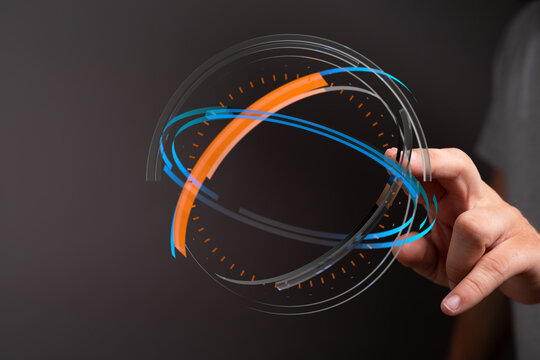 A close-up of a hand interacting with a glowing futuristic hologram circle. Technology, innovation, and digital interface concept. Da