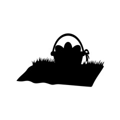 Silhouette of Easter egg basket hiding in the grass on an isolated background