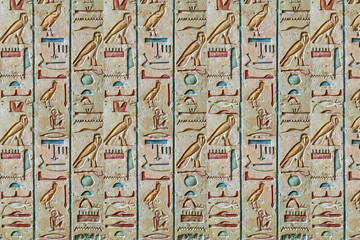 Obraz premium Hieroglyphic-inspired 3D mural with carved blocks arranged in repeating vertical patterns for a historical artistic finish. 