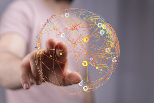 Hand reaching towards a digital sphere, symbolizing global network, connection, and data visualization. Perfect for technology and bu